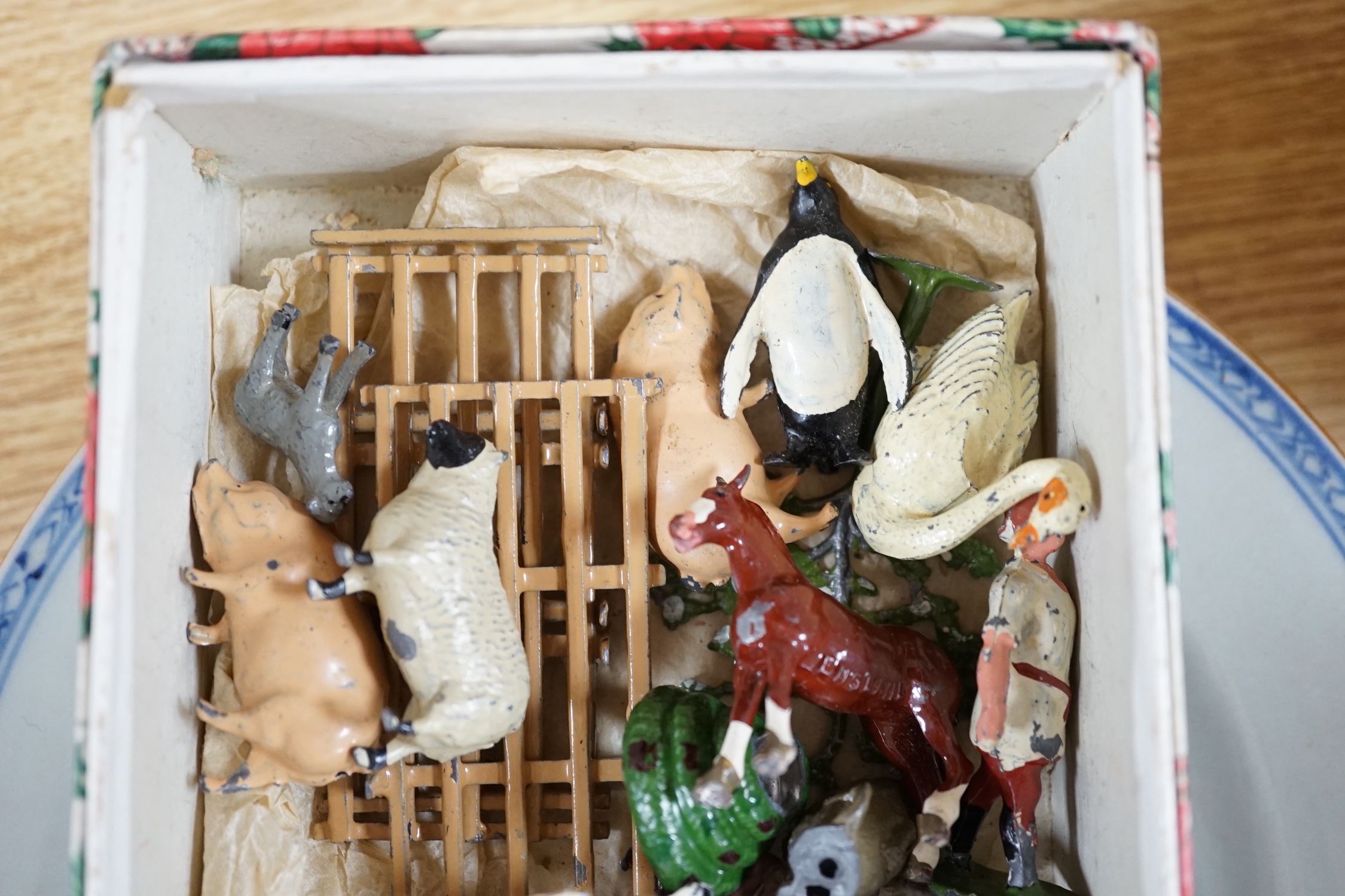 Britains farm series, a Schuco type monkey and a Huntley & Palmers novelty farmhouse biscuit tin, 16cm wide
